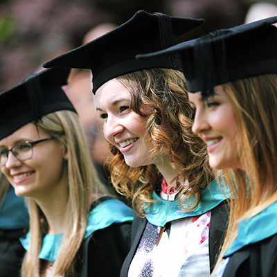 female students smiling in graduation