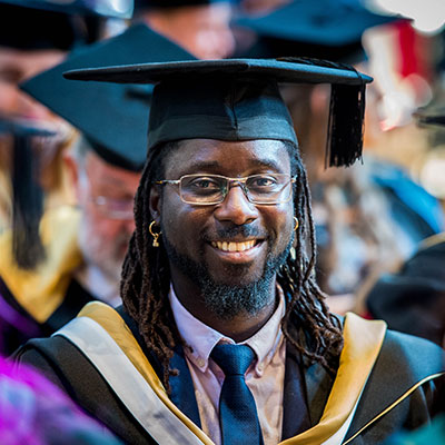 student smiling in graduation