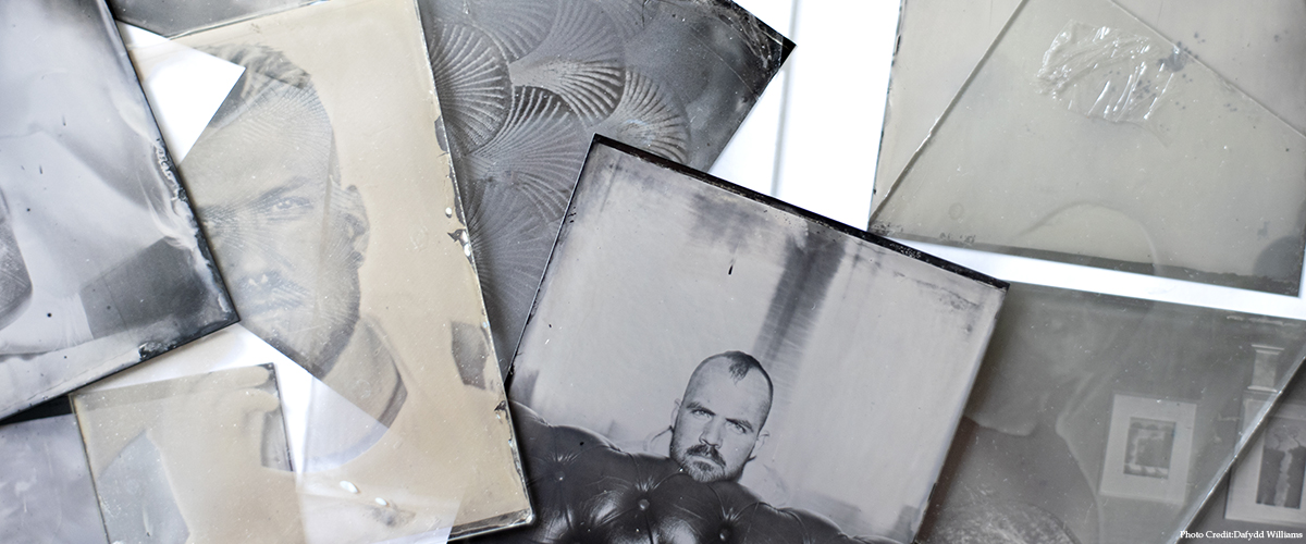 Work by Dafydd Williams: monochrome photos lie mixed among old glass dust covers.